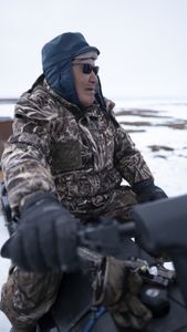 John Pingayak travels on his four wheeler in the tundra. (National Geographic/Matt Kynoch)