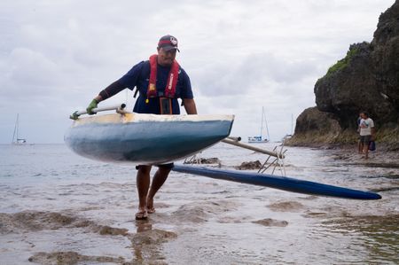 A Niuean fisherman carries his vaka ashore. Vakas are traditional double-hulled canoes that are used to navigate and fish in rough Pacific waters. National Geographic Pristine Seas explored the marine ecosystem in Niue -a small island nation in the tropical Pacific. Local and international scientists surveyed the ocean to understand its health and biodiversity. Thanks to local leadership, traditional knowledge, and strong science, the country has been able to protect large swaths of its marine environment. (National Geographic/Nova West)