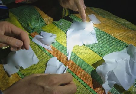 Hands and notes are seen  on found contraband in Fajardo, PR. (Lucky 8 TV)