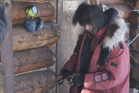 Ricko DeWilde bear proofs his cabin before he leaves for the remainder of the season. (BBC Studios Reality Productions, LLC/JR Masters)