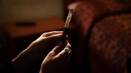 Mariana van Zeller holds the Funeral Director's pen with a sliver of human brain inside. (National Geographic for Disney)