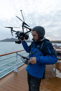 Drone operator Raphael Boudreault-Simard launches a DJI Inspire 2 off the deck of the M/V National Geographic Explorer expedition ship. (National Geographic for Disney/Ruth Davies)