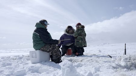 John and Teresa Pingayak with their grandson, Asher Ulroan, ice fishing. (National Geographic/Matt Kynoch)