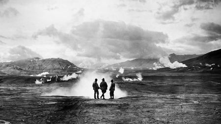 Three members of the National Geographic Expedition to The Valley of Ten Thousand Smokes standing near a large steam vent. (credit: National Geographic Society)