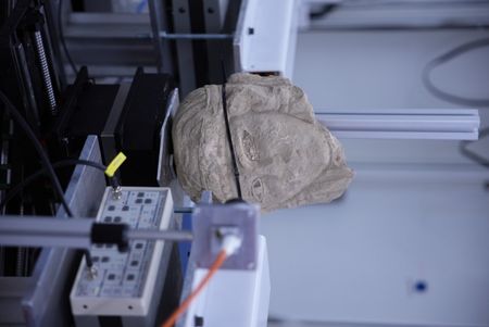 The stone head is scanned at the SESAME laboratory to find out further details about the recently unearthed sample. (Windfall Films/Alex Collinge)