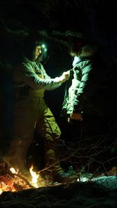 Ricko DeWilde and his daughter, Skarlett warm up in the winter by the open fire. (BBC Studios Reality Productions, LLC/Jensen Walker)