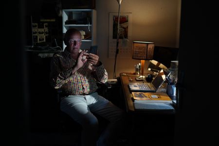 Stéphane Bourgoin is a French author and renowned specialist on serial killers, who since 2019 has been at the center of an internet-led controversy spearheaded by a group of anonymous true crime fans.  Here, Bourgoin uses his phone during the production of "Killer Lies: Chasing a True Crime Con Man," a documentary series about obsession and deception, following the unraveling of Stephane Bourgoin’s career as a best-selling author and serial killer expert. (National Geographic/Ben Selkow)