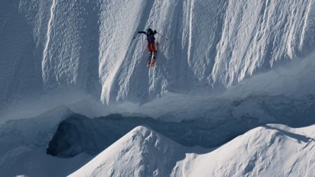 Angel Collinson jumps over a crevasse as she skis down a mountain in Alaska.  (mandatory credit:  Teton Gravity Research)
