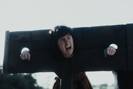 Locked in a pillory, Janet Latimer screams. (Dash Productions Services LTD/Antoan Ivanov)