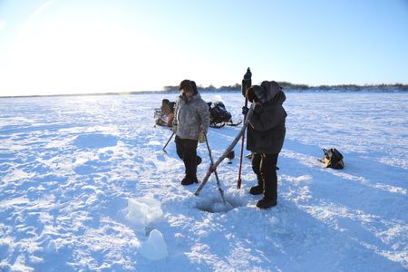 Brothers, Avery and Gage Hoffman set fish nets under the ice for subsistence food for their family and community. (BBC Studios Reality Productions, LLC/Isaiah Branch - Boyle)