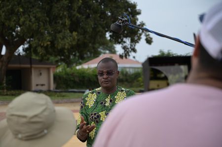 Alex Amoussouvi, a local guide, explains the history of Ouidah's slave market, once the busiest in West Africa. (National Geographic/Etinosa Yvonne)