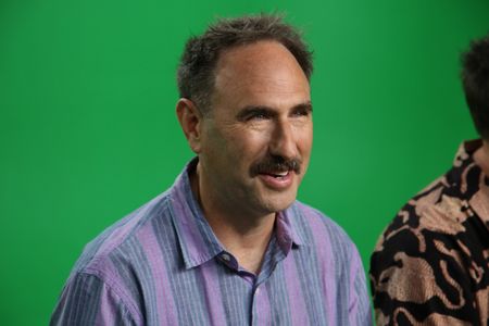 Randy Sklar laughing Infront of a green screen. (National Geographic/Robert Toth)