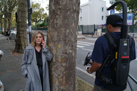 In this behind-the-scenes photo, The New Yorker staff writer Lauren Collins speaks on the phone in a behind-the-scenes photo from for "Killer Lies: Chasing a True Crime Con Man," a documentary series about obsession and deception, following the unraveling of French serial-killer expert Stephane Bourgoin’s career as a best-selling author and serial killer expert. (National Geographic/Ben Selkow)