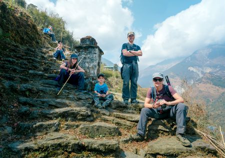 Leo, Colin, Laurent, Mia, Sebastien Pelletier, a local sherpa, and Edith Lemay take a brief rest while trekking to the Poon Hill viewpoint in Nepal. (Credit: MRC/Jean-Sébastien Francoeur)