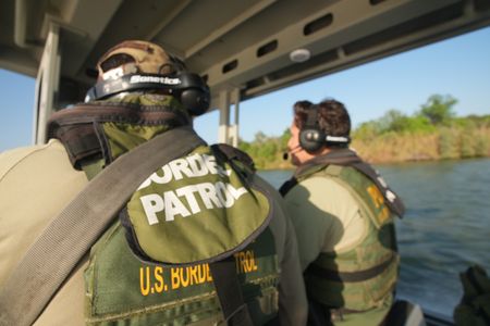 Border Patrol Agents Weeks and Gonzalez are pictured on a boat while looking for signs of illegal migrants in the Rio Grande River in the Rio Grande Valley, Texas. (National Geographic)