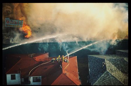 Rooftops going up in smoke on an unidentified street during the riots of 1992, following the decision in the Rodney King case.