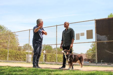 Cesar talks to Todd while he holds Isley on a leash. (National Geographic)