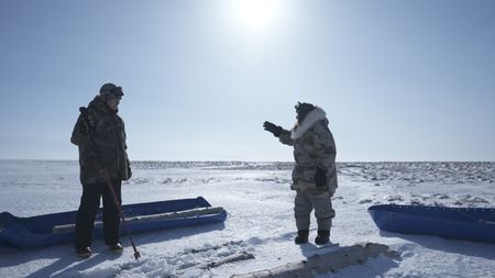 John Pingayak and his grandson, Sonna Boy collect wood along the frozen tundra. (National Geographic/Matt Kynoch)