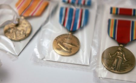 Doris Miller's medals are displayed in Flosetta Miller's home in Arlington, Texas. "Erased: WW2's Heroes of Color" tells the stories of three Black heroes who miraculously survived the attack on Pearl Harbor. One of these men, mess attendant Doris Miller, defied racial stereotypes when he shot down enemy planes during the attack. (National Geographic/Nelson Adeosun)