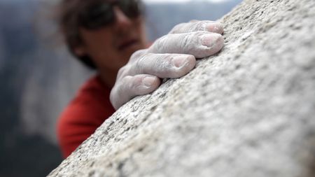 Jimmy Chin reaches for a hold as he climbs a wall.  (credit: Jimmy Chin Productions)