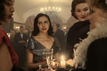 A SMALL LIGHT - Miep, played by Bel Powley, and Tess, played by Eleanor Tomlinson, attend a party in A SMALL LIGHT. (Credit: National Geographic for Disney/Dusan Martincek)