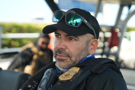 A CBP Agent rides in a water vessel in Fajardo, P.R. (Lucky 8 TV/Ivan Leon)