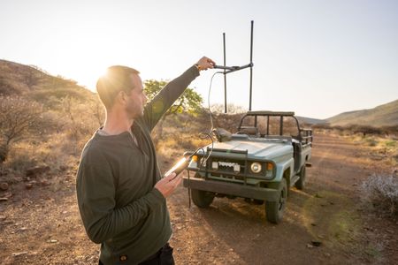 Giles Clark searches for Elektra the pangolin using radio telemetry. (National Geographic/Mark Challender)