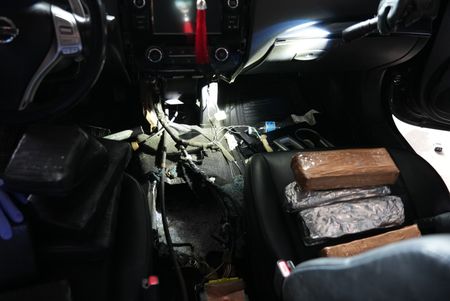 Multiple packages of suspected narcotics are sitting on the driver's seat and passenger seat of a suspect's vehicle after they were found smuggled in Brownsville, Texas. (National Geographic)