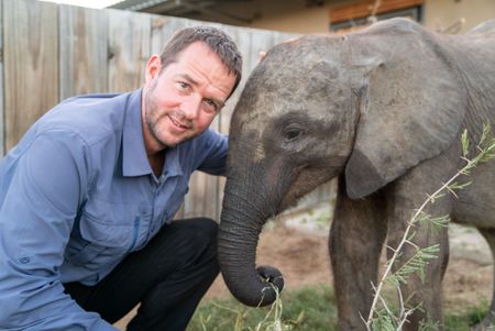 Giles Clark and Phabeni the elephant orphan. (National Geographic/Cherique Pohl)