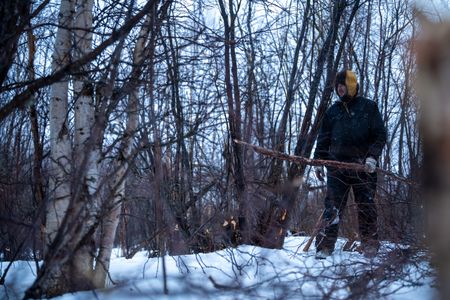 Chevie Roach builds a blind out of branches during the migratory water fowl season. (BBC Studios Reality Productions/Jayce Kolinski)