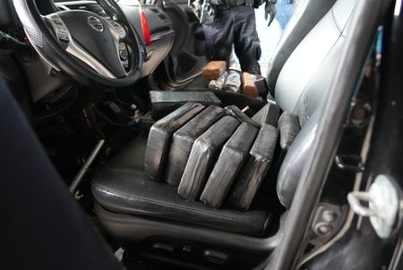 Multiple packages of suspected narcotics are sitting on the driver's seat and passenger seat of a suspect's vehicle after they were found smuggled in Brownsville, Texas. (National Geographic)