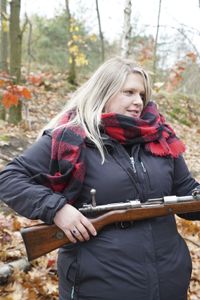 Alina Nowobilska holding a rifle used during the 1920 Battle of Warsaw. (National Geographic/Ciaran Henry)