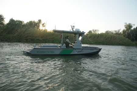 Border Patrol Agents Weeks and Gonzalez are pictured on a boat while looking for signs of illegal migrants in the Rio Grande River in the Rio Grande Valley, Texas. (National Geographic)