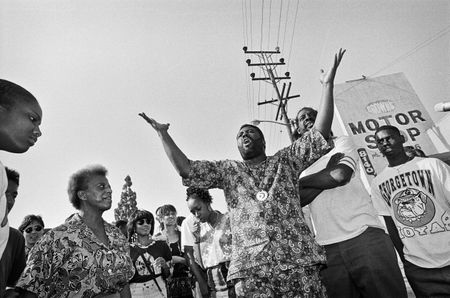 South Central LA residents gather on a street corner to ask fellow residents to stop the violence and rioting. Los Angeles has undergone several days of rioting due to the acquittal of the LAPD officers who beat Rodney King. Hundreds of businesses were burned to the ground and over 55 people have been killed. (Photo by Ted Soqui/Corbis via Getty Images)