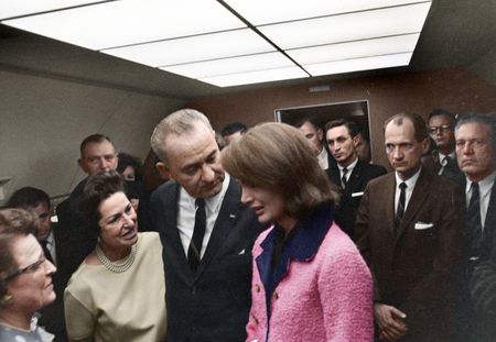 This colorized archival image shows the swearing-in ceremony of Lyndon B. Johnson (LBJ) as President aboard Air Force One with former first lady Jacqueline Kennedy standing next to him, Nov. 22, 1963, in Dallas. (Cecil Stoughton/White House Photographs/John F. Kennedy Presidential Library and Museum, Boston)