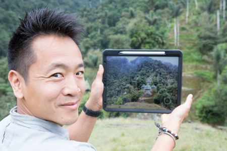 Ciudad Perdida, Colombia - Dr. Albert Lin uses his tablet to reveal the wooden huts which would have covered each stone terrace of Ciudad Perdida at the time of the Tairona. (Blakeway Productions/National Geographic)