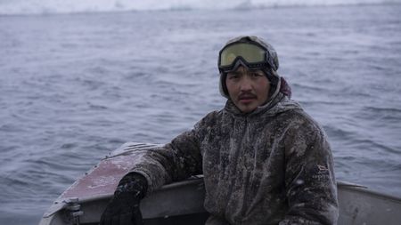 Chris Apassingok hunting seals with his family. (National Geographic/Zach Clanton)