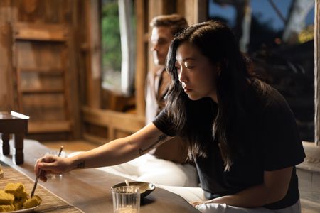 Awkwafina tries the tteok she made earlier in the day. (Credit: National Geographic/Seong Joon Cho)