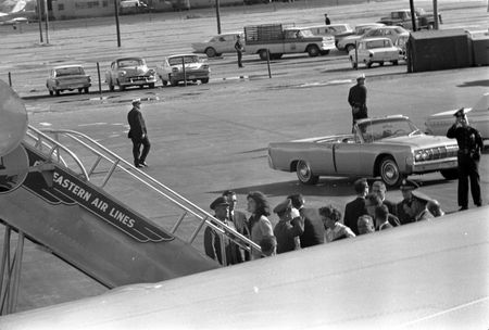 Jacqueline Kennedy and other members of the Presidential party including Lawrence O'Brien, Kenneth O'Donnell, General Clifton, and Dave Powers, prepare to board Air Force One after President John F. Kennedy's casket was carried onto the plane at Love Field in Dallas, Nov. 22, 1963. (Cecil Stoughton/White House Photographs/John F. Kennedy Presidential Library and Museum, Boston)