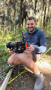 Camera assistant Nick Widdop looks at a monarch butterfly that has landed on his camera. (National Geographic for Disney/Imogen Prince)