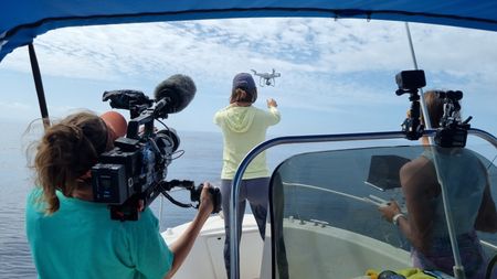 Ruth Davies films whale researchers Shannon Malone and Tess Herman as they deploy a drone. (National Geographic for Disney/Rory Dormer)
