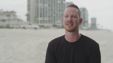 Mark Bowden, shark attack survivor being interviewed on Coronado Beach, San Diego, as he recalls his encounter with a shark and the injuries he sustained. (National Geographic)