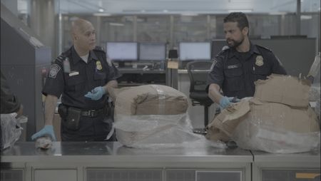 CBP Officers Islam and Hundal use knives to inspect a passenger's boxes, searching for customs violations at the Dulles International Airport in Dulles, Va. (National Geographic)