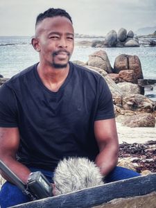 Gibbs Kuguru being interviewed at Millers Point, Cape Town. (National Geographic/Robert Cowling)