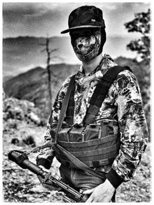 A masked narco masked holds a rifle in the Sinaloa mountains.  (Nick Quested)