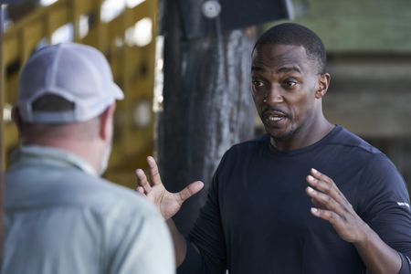 Anthony Mackie speaks to scientist Dr. Marcus Drymon on the shores of Lake Pontchartrain. (National Geographic/Brian Roedel)
