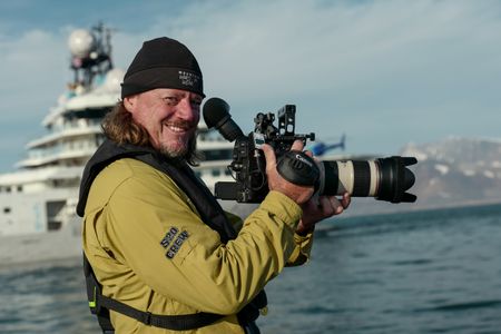 Cameraman Michael McAleenan in front of the OceanXplorer. (National Geographic/Mario Tadinac)