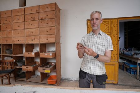 Henning Franzmeier examines items in the storeroom of Pi Ramesses in Egypt. (Windfall Films)