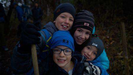 Clockwise from top left: Leo, Mia, Laurent and Colin Pelletier hug in front of the camera. (Credit: MRC/Jean-Sébastien Francoeur)