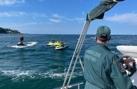 A civil guard observes three jet skis in Spain. (Guardia Civil)